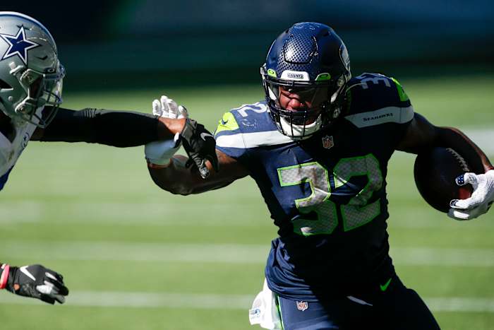 Seattle Seahawks running back Chris Carson (32) rushes against the Dallas Cowboys during the second quarter at CenturyLink Field.